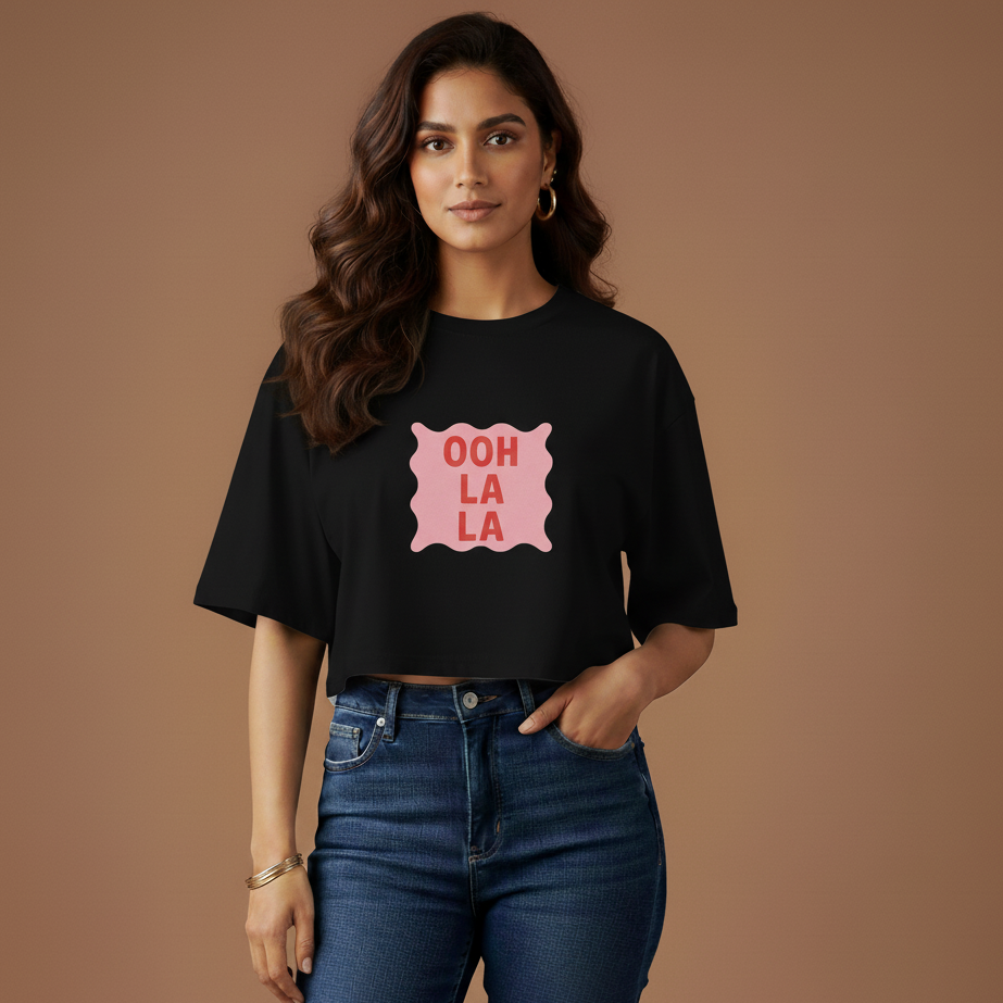 Woman wearing a black t-shirt with 'Ooh La La' design on a brown background