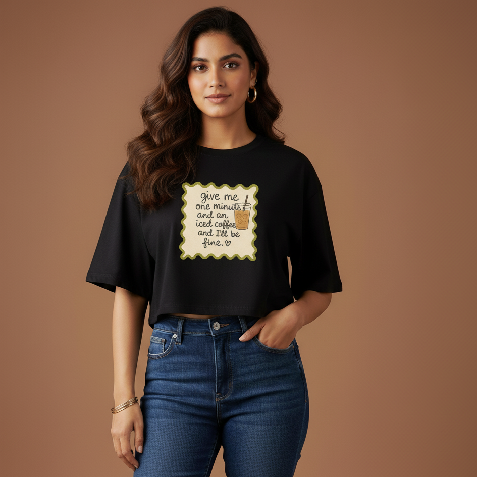 Woman wearing a black t-shirt with a graphic and text against a brown background