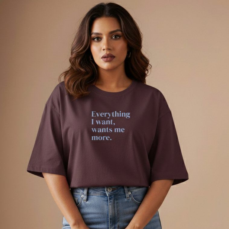 Woman wearing a maroon t-shirt with text on a beige background
