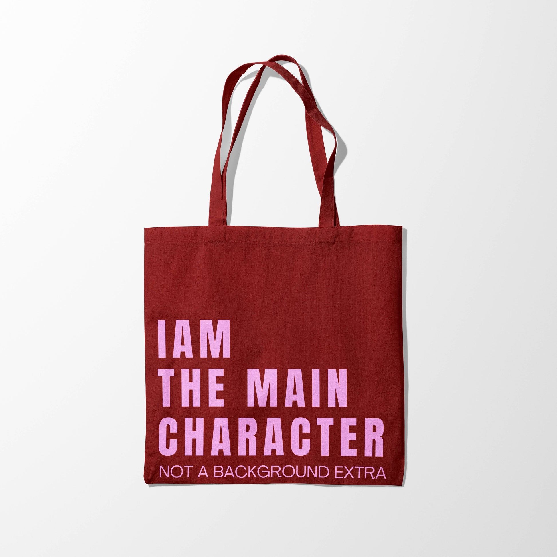 Red tote bag with pink text on a white background