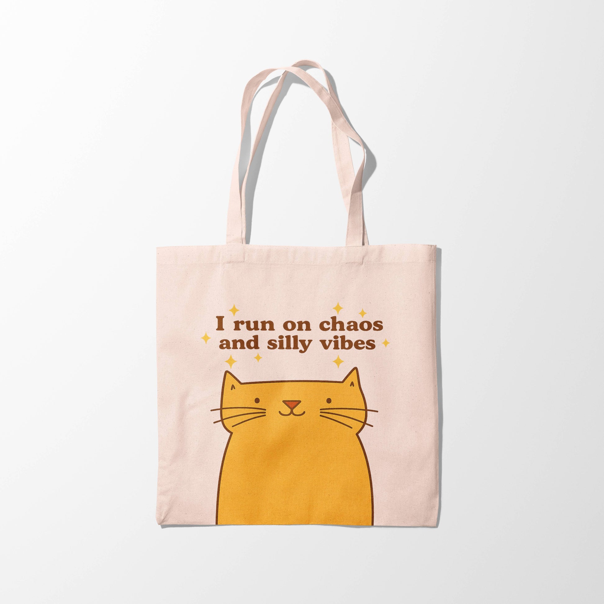 Tote bag with a cat illustration and text on a white background