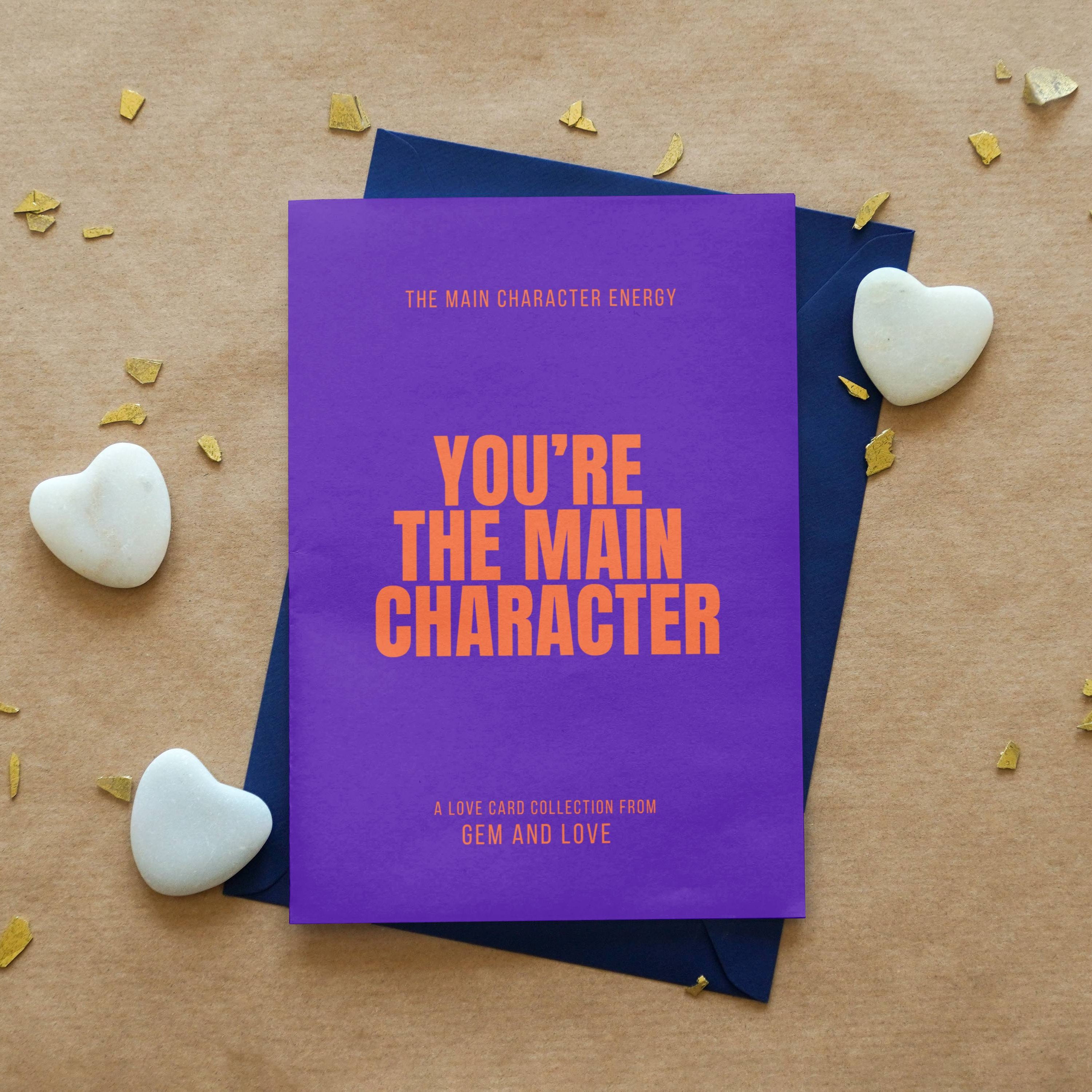 Purple book titled 'You're the Main Character' on a wooden surface with decorative elements.